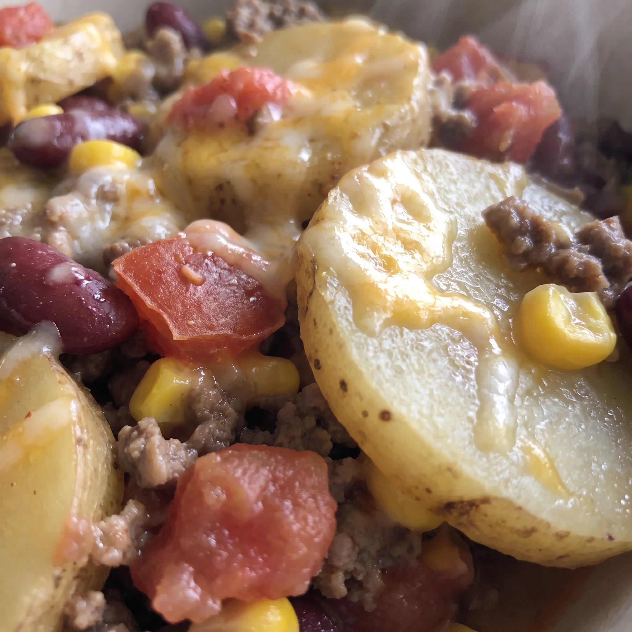 Bubbling Colby Jack crust with creamy potato chunks, ground beef, kidney beans and corn in a thick red tomato sauce.